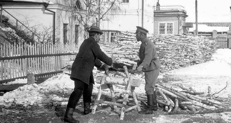 Nicholas II and an unidentified man sawing wood during the captivity at Tobolsk.